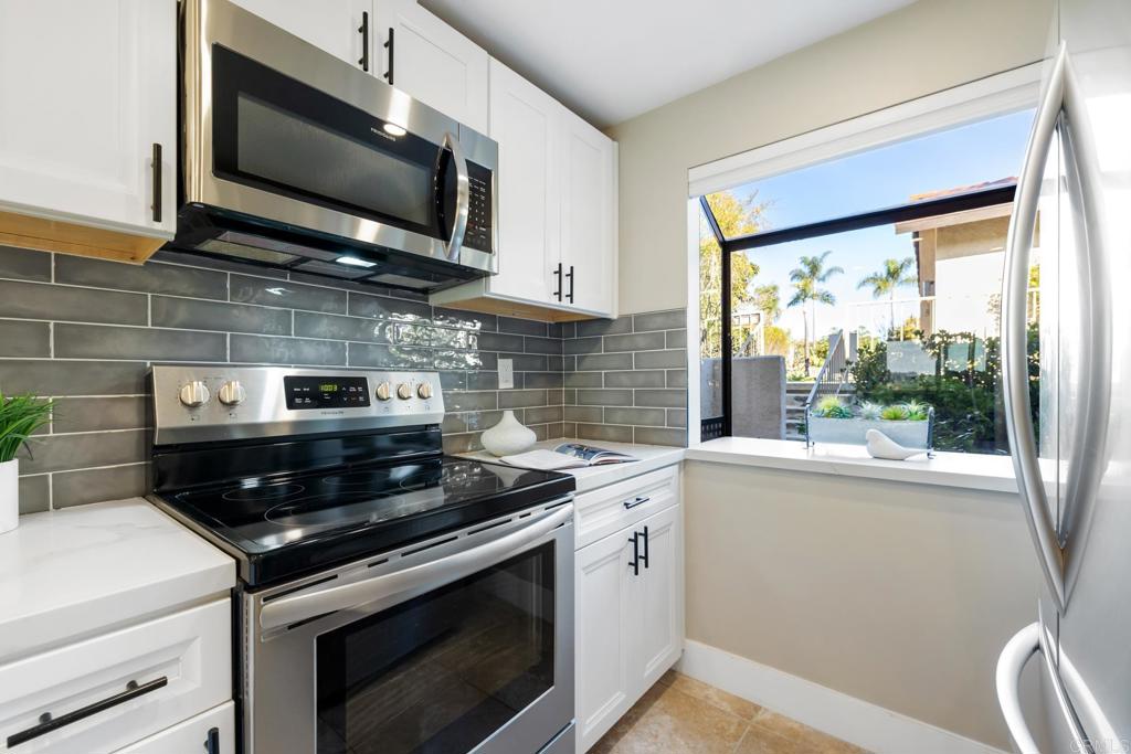 132 South Jayton Lane Encinitas, CA 92024 - Photo 7 of 37 a kitchen with a stove and a microwave