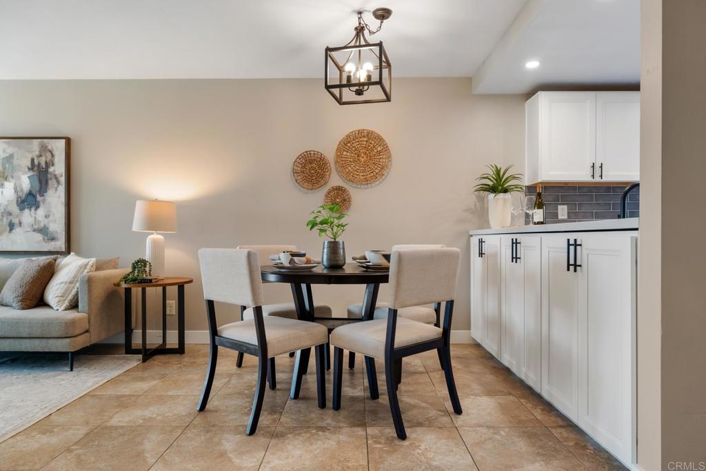 132 South Jayton Lane Encinitas, CA 92024 - Photo 8 of 37 a view of a dining room with furniture a chandelier and wooden floor