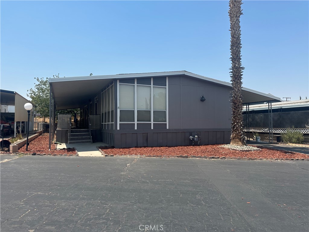 701 Montara Road, Unit 207 Barstow, CA 92311 - Photo 1 of 1 a view of a house with a patio and a yard
