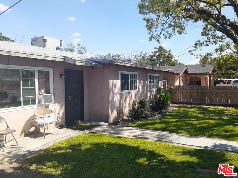 a view of a house with backyard porch and sitting area