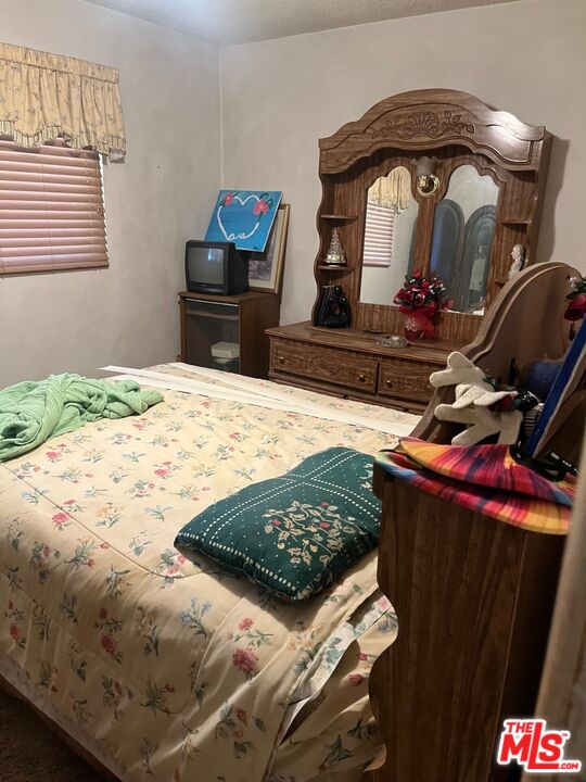 1605 Madison Street Bakersfield, CA 93307 - Photo 4 of 8 a bedroom with a bed and a dresser