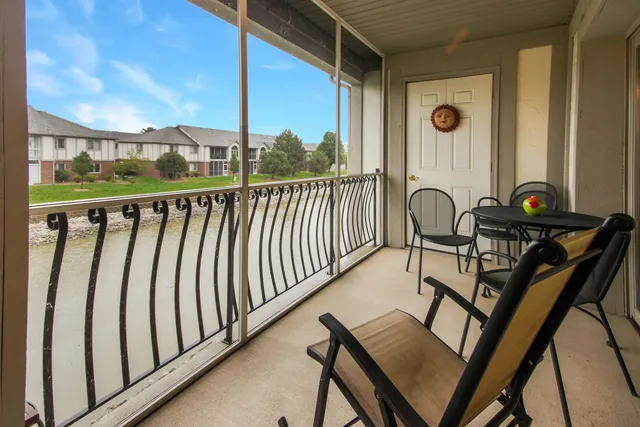 a view of a chairs and table in the balcony