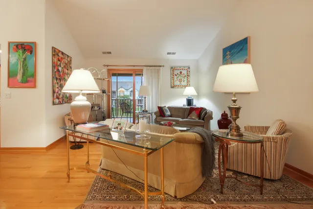 a living room with furniture a window and a lamp