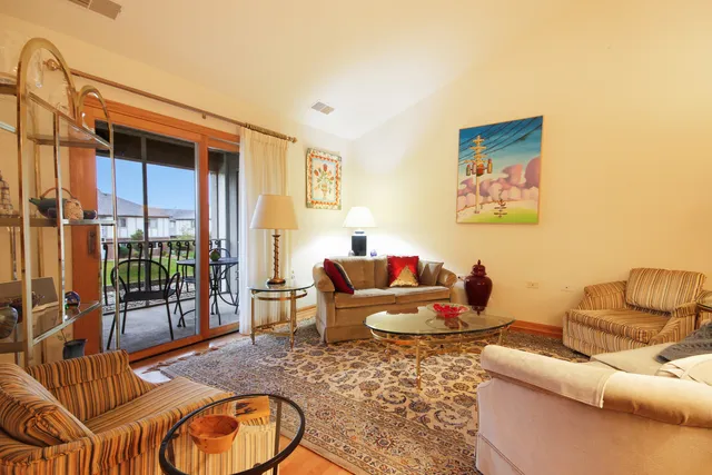 a living room with furniture and a floor to ceiling window