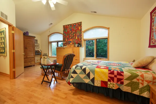 a bedroom with a bed and a table in it