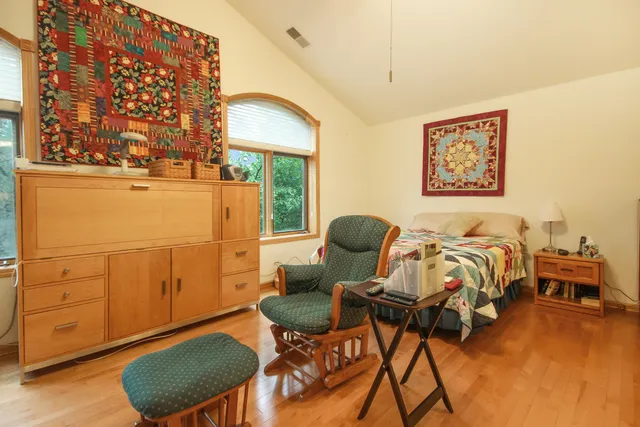 a bed room with a bed and a chair