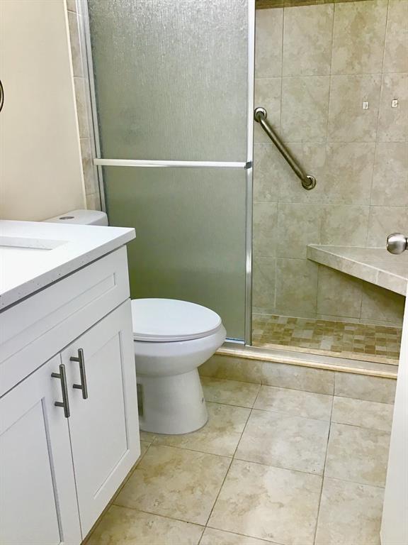 3032 Exeter, Unit 3032 Boca Raton, FL 33434 - Photo 11 of 32 a bathroom with a toilet and a shower