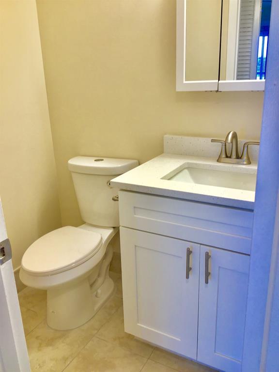 3032 Exeter, Unit 3032 Boca Raton, FL 33434 - Photo 12 of 32 a bathroom with a sink and a toilet