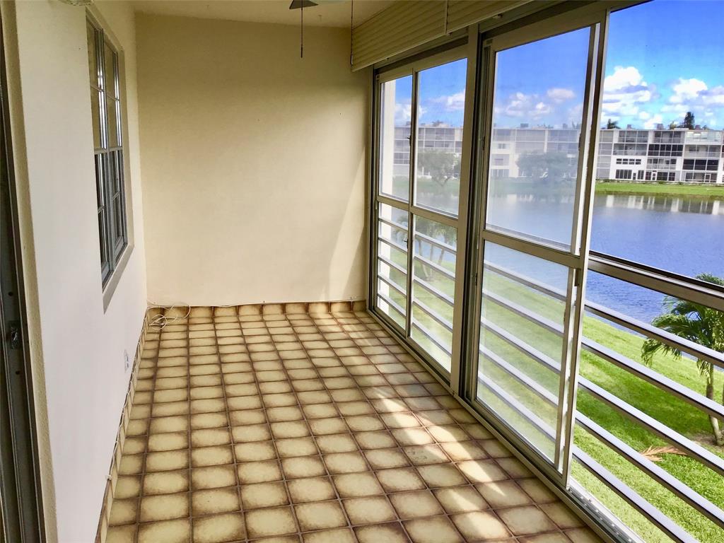 3032 Exeter, Unit 3032 Boca Raton, FL 33434 - Photo 23 of 32 a view of a balcony with wooden floor