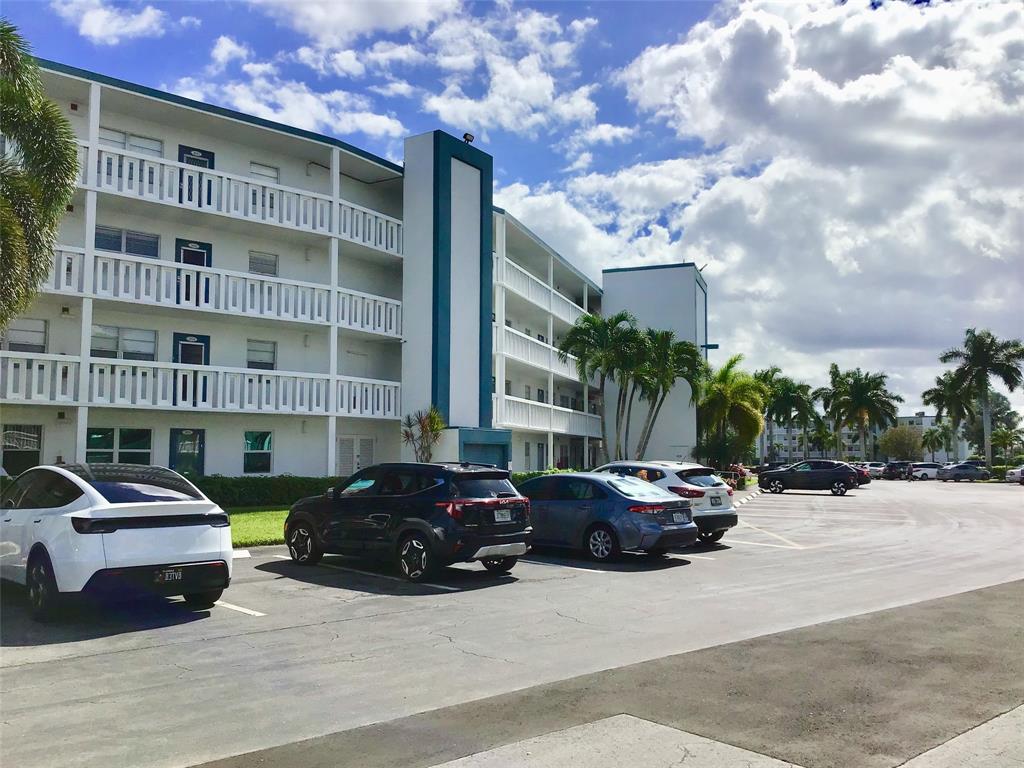 3032 Exeter, Unit 3032 Boca Raton, FL 33434 - Photo 26 of 32 a view of a cars parked in front of a building