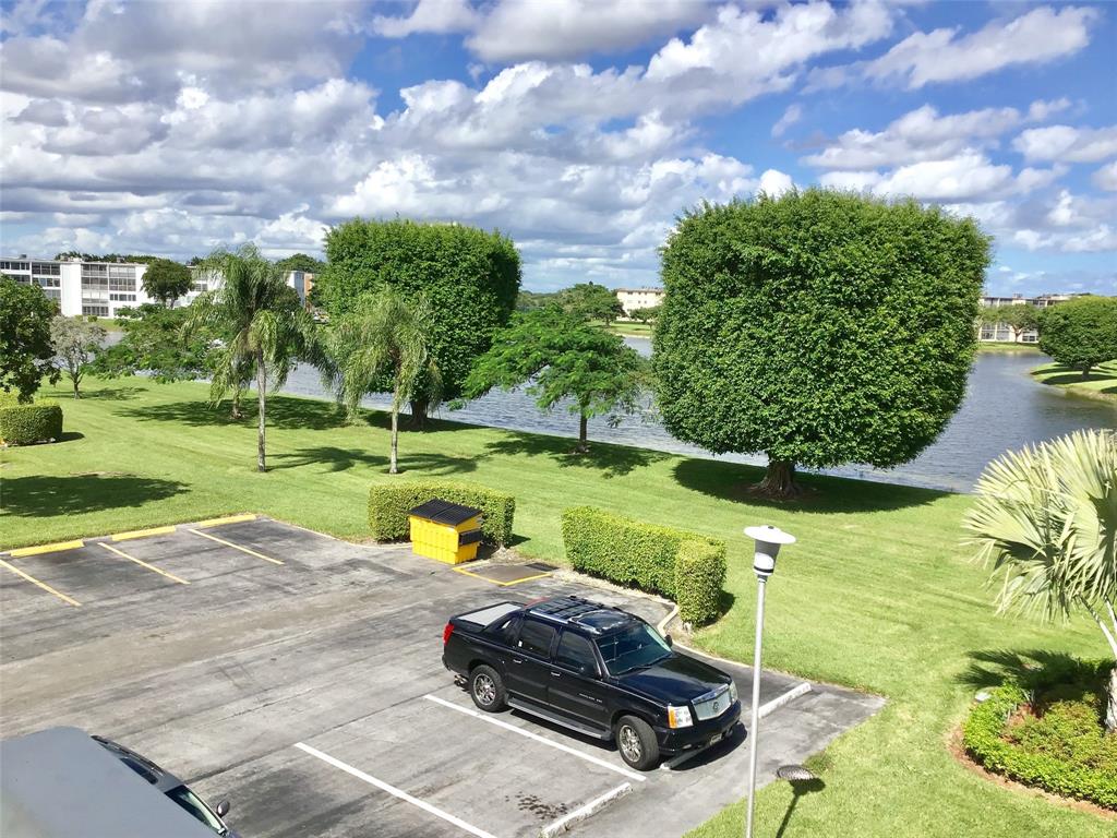 3032 Exeter, Unit 3032 Boca Raton, FL 33434 - Photo 28 of 32 a view of a lake with a yard