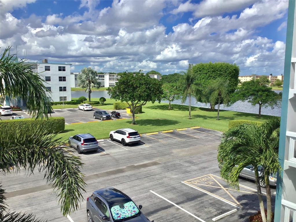 3032 Exeter, Unit 3032 Boca Raton, FL 33434 - Photo 29 of 32 a view of a street with a yard