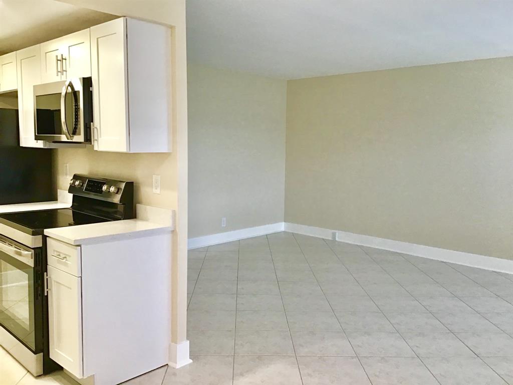 3032 Exeter, Unit 3032 Boca Raton, FL 33434 - Photo 6 of 32 a view of storage and utility room with washer and dryer