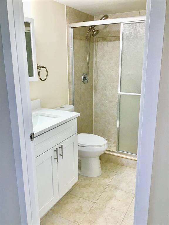 3032 Exeter, Unit 3032 Boca Raton, FL 33434 - Photo 10 of 32 a bathroom with a sink a toilet and shower