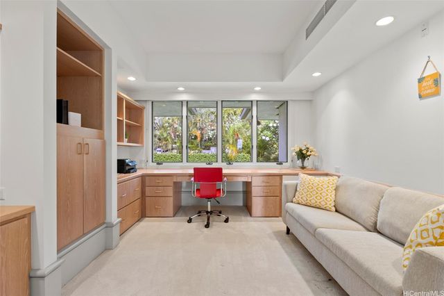 a view of a livingroom with workspace and a window