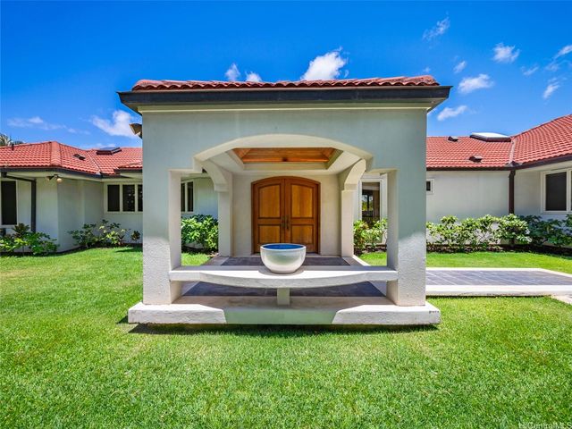 a view of a house with backyard sitting area and garden