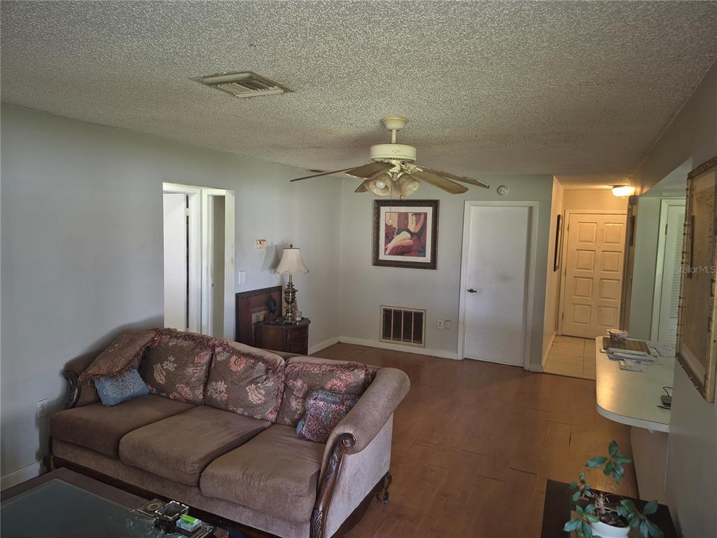 13710 Whitby Road Hudson, FL 34667 - Photo 13 of 21 a living room with furniture and a flat screen tv
