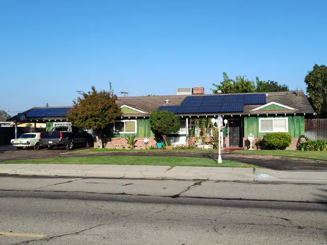 a front view of a house with a yard table and chairs