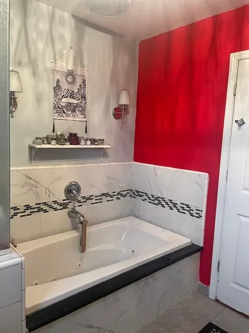 a bathroom with a bathtub and shower