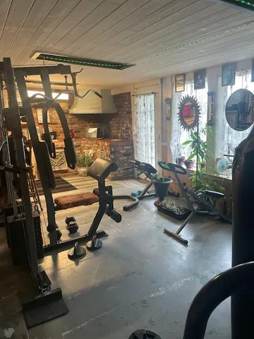 a room with gym equipment and a large window
