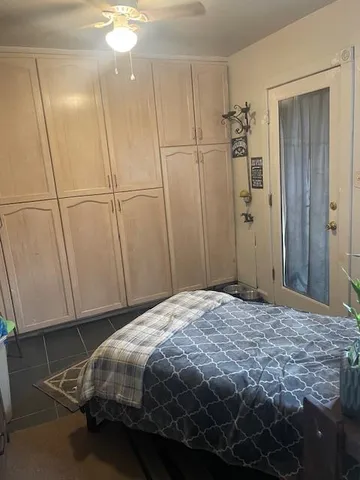a bedroom with a bed and a cabinet