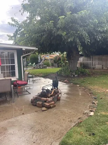 a backyard of a house with yard fire pit and outdoor seating
