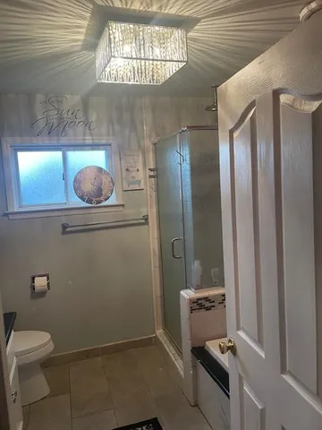 a bathroom with a toilet and a shower