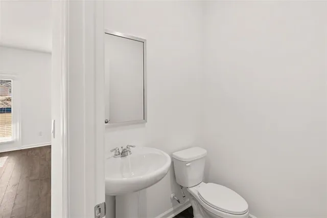 a white toilet sitting next to a white sink