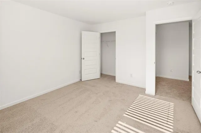 a view of a room with wooden floor and a rug