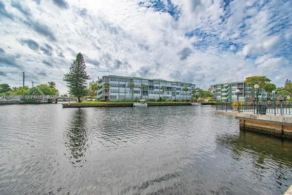 a view of a lake with houses in the background
