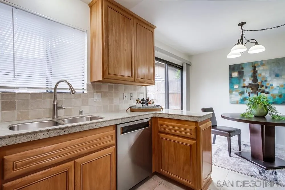 8918 Fletcher Valley Dr. Santee, CA 92071 - Photo 13 of 31 a kitchen with stainless steel appliances granite countertop a sink a stove and cabinets