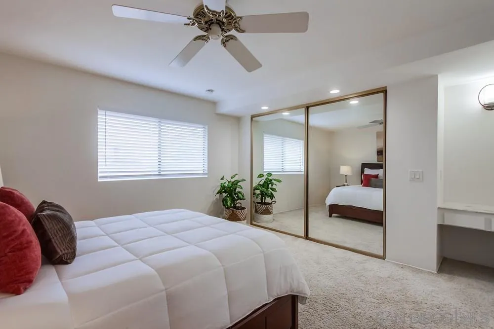 8918 Fletcher Valley Dr. Santee, CA 92071 - Photo 18 of 31 a bedroom with a large bed and a chandelier
