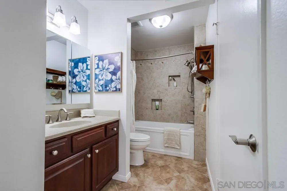 8918 Fletcher Valley Dr. Santee, CA 92071 - Photo 20 of 31 a bathroom with a granite countertop sink a toilet and shower