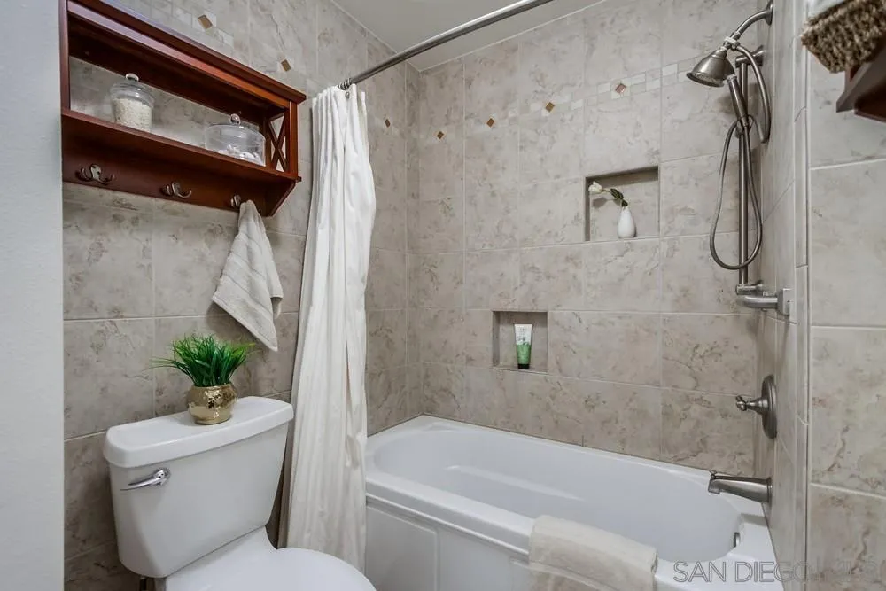 8918 Fletcher Valley Dr. Santee, CA 92071 - Photo 21 of 31 a bathroom with a toilet and a bathtub