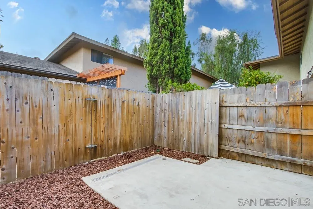 8918 Fletcher Valley Dr. Santee, CA 92071 - Photo 27 of 31 a front view of a house with a wooden fence