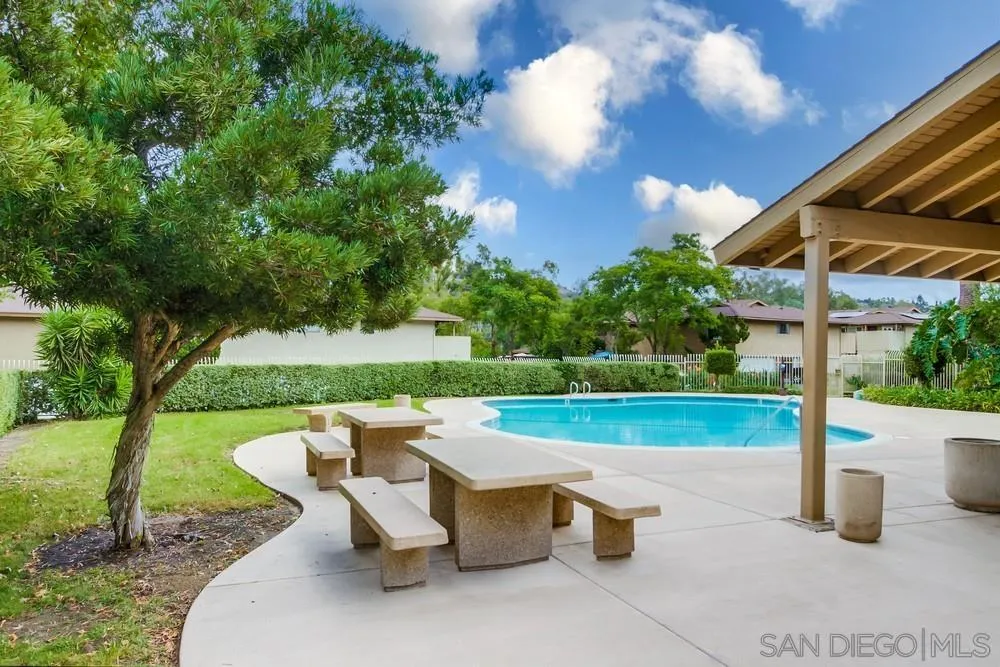 8918 Fletcher Valley Dr. Santee, CA 92071 - Photo 31 of 31 a view of a patio with a table & chairs under an umbrella
