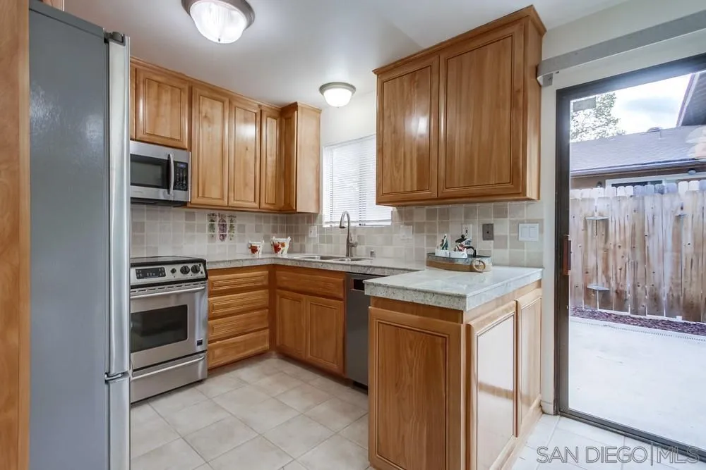 8918 Fletcher Valley Dr. Santee, CA 92071 - Photo 10 of 31 a kitchen with stainless steel appliances granite countertop a stove a sink and a refrigerator