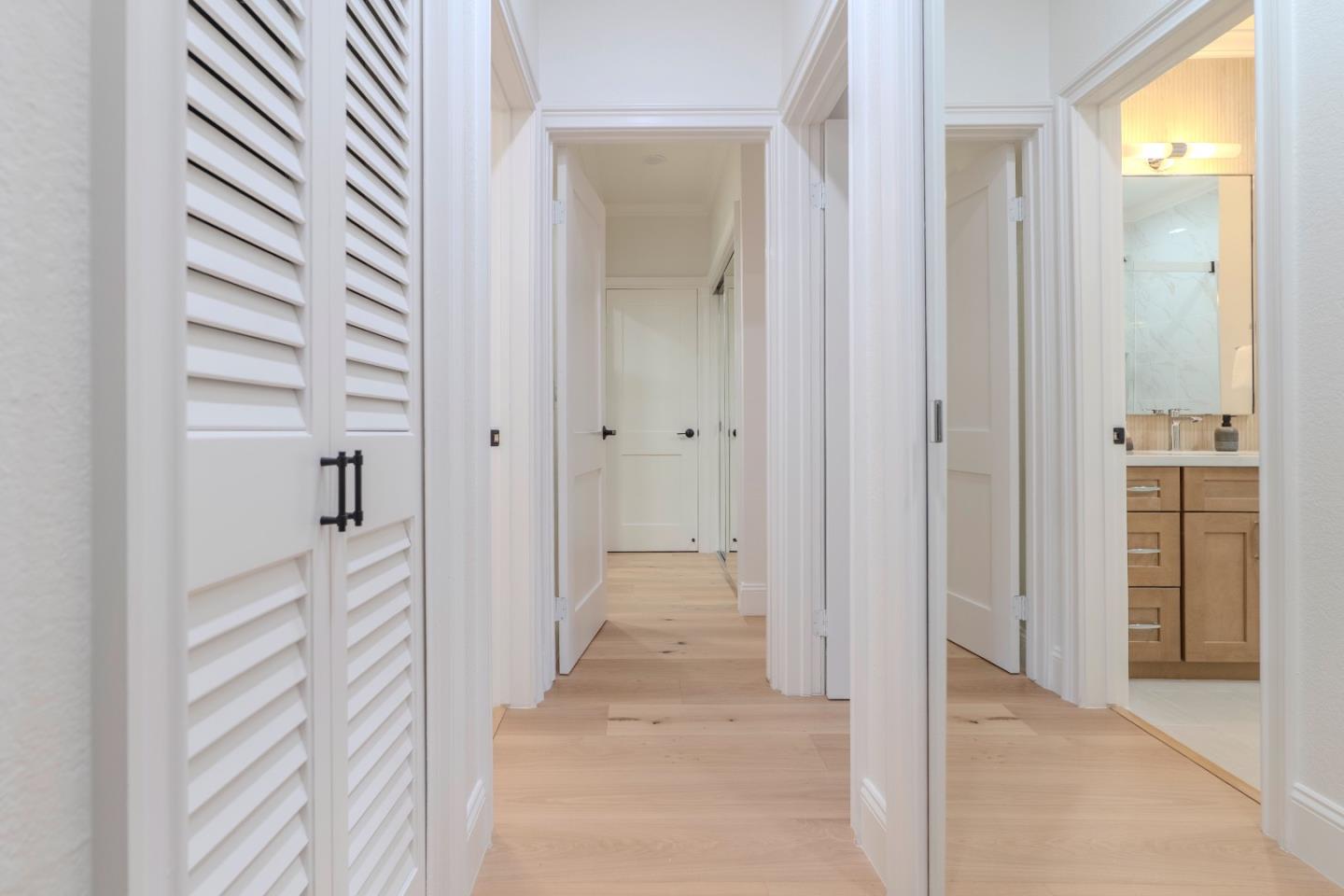 22330 Homestead Road, Unit 116 Cupertino, CA 95014 - Photo 18 of 30 a view of a hallway with wooden floor and staircase