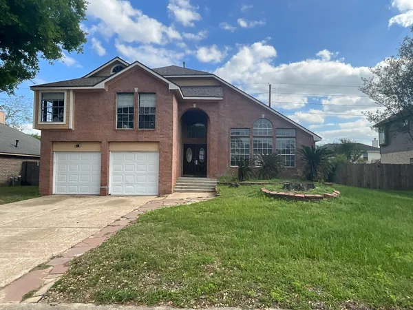 a view of a house with a yard and garage