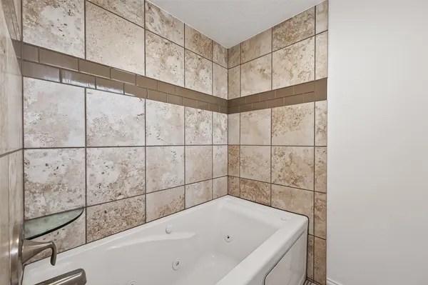 a bathroom with a bathtub and shower