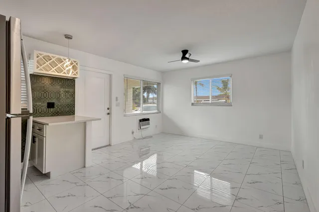 a view of a livingroom with furniture and windows