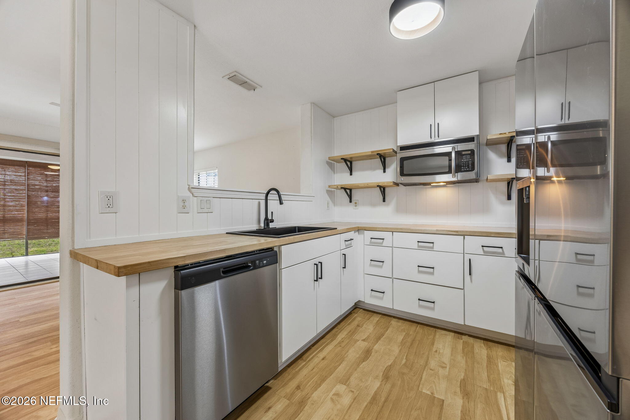 10150 Belle Rive Boulevard, Unit 1109 Jacksonville, FL 32256 - Photo 11 of 55 a kitchen with a sink and cabinets