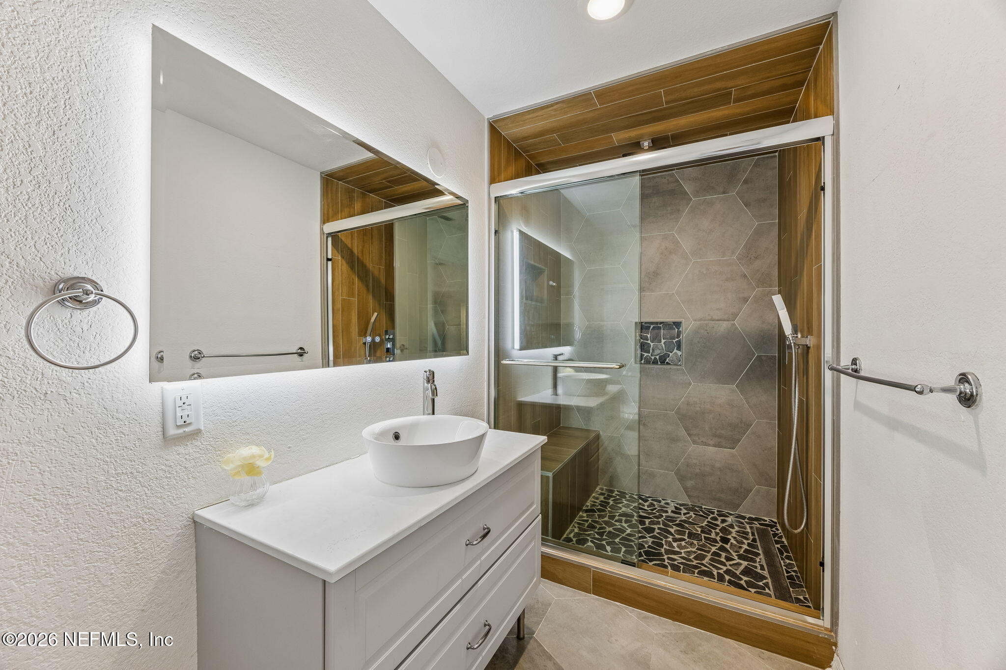 10150 Belle Rive Boulevard, Unit 1109 Jacksonville, FL 32256 - Photo 17 of 55 a bathroom with a shower and a sink
