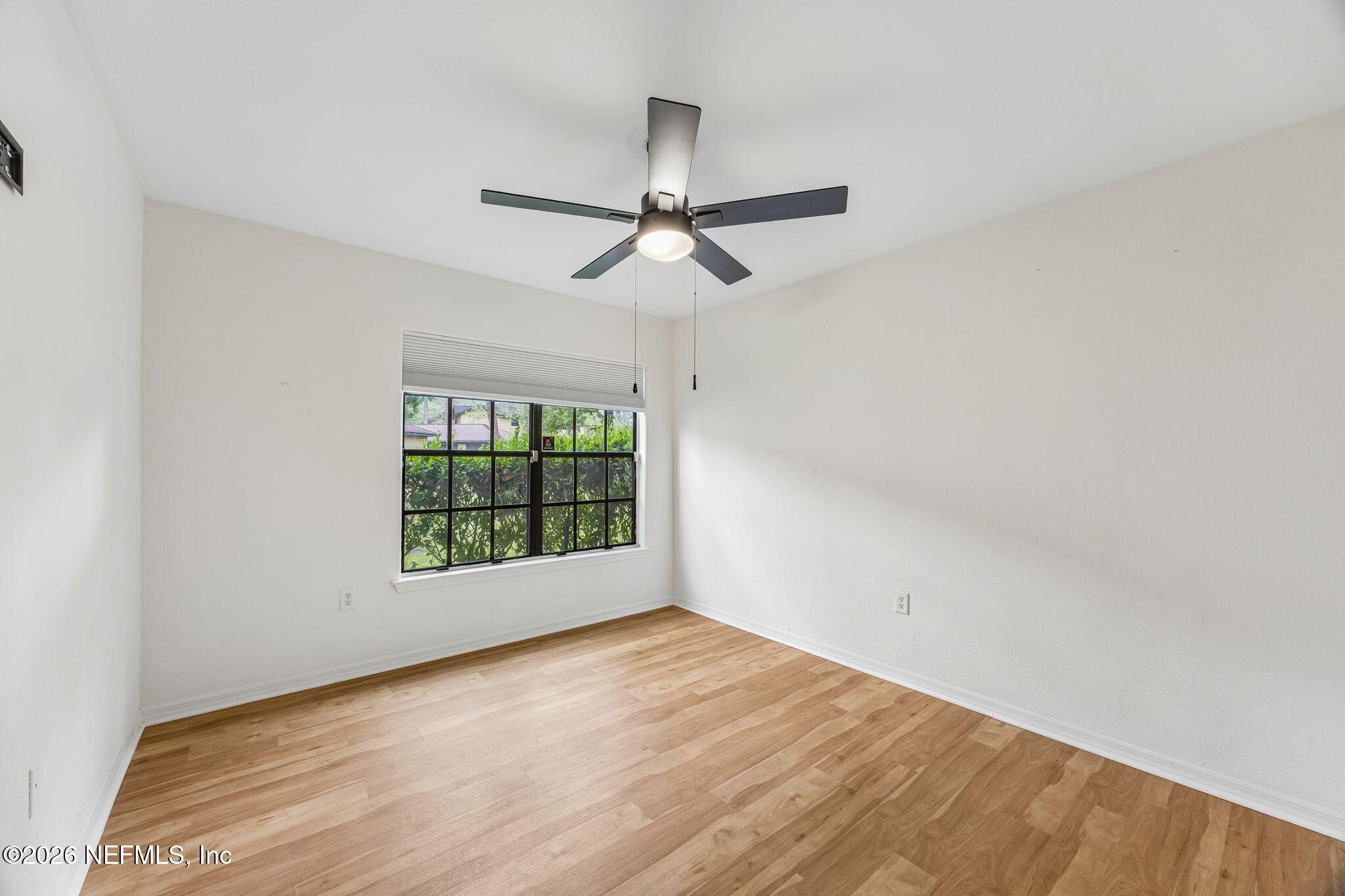 10150 Belle Rive Boulevard, Unit 1109 Jacksonville, FL 32256 - Photo 19 of 55 wooden floor in an empty room with a window