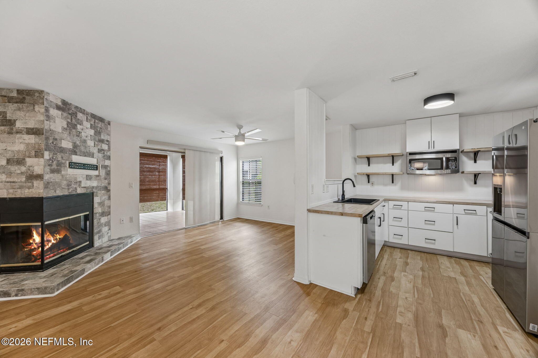 10150 Belle Rive Boulevard, Unit 1109 Jacksonville, FL 32256 - Photo 2 of 55 a kitchen with stainless steel appliances granite countertop a stove top oven a sink dishwasher and a fireplace with wooden floor