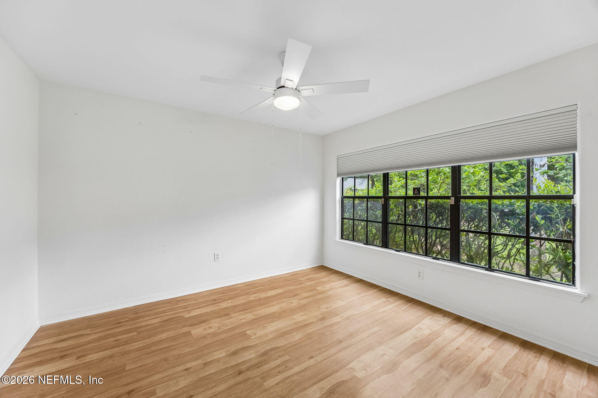 10150 Belle Rive Boulevard, Unit 1109 Jacksonville, FL 32256 - Photo 23 of 55 wooden floor in an empty room with a window