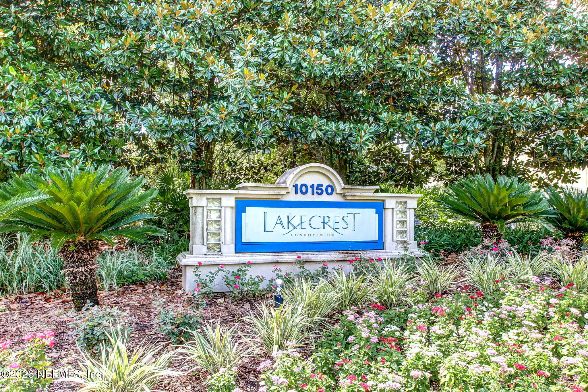 10150 Belle Rive Boulevard, Unit 1109 Jacksonville, FL 32256 - Photo 33 of 55 a sign that is sitting in a garden