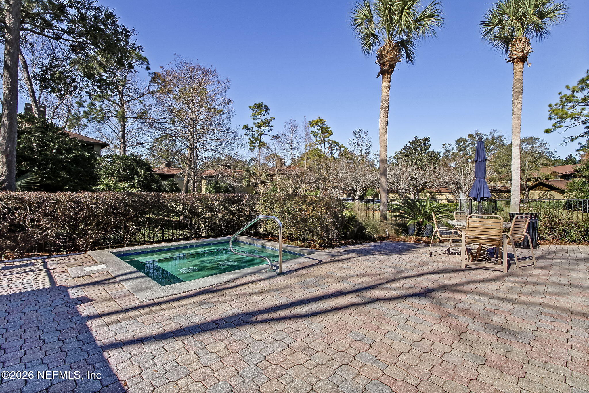 10150 Belle Rive Boulevard, Unit 1109 Jacksonville, FL 32256 - Photo 40 of 55 a view of a bench in a garden