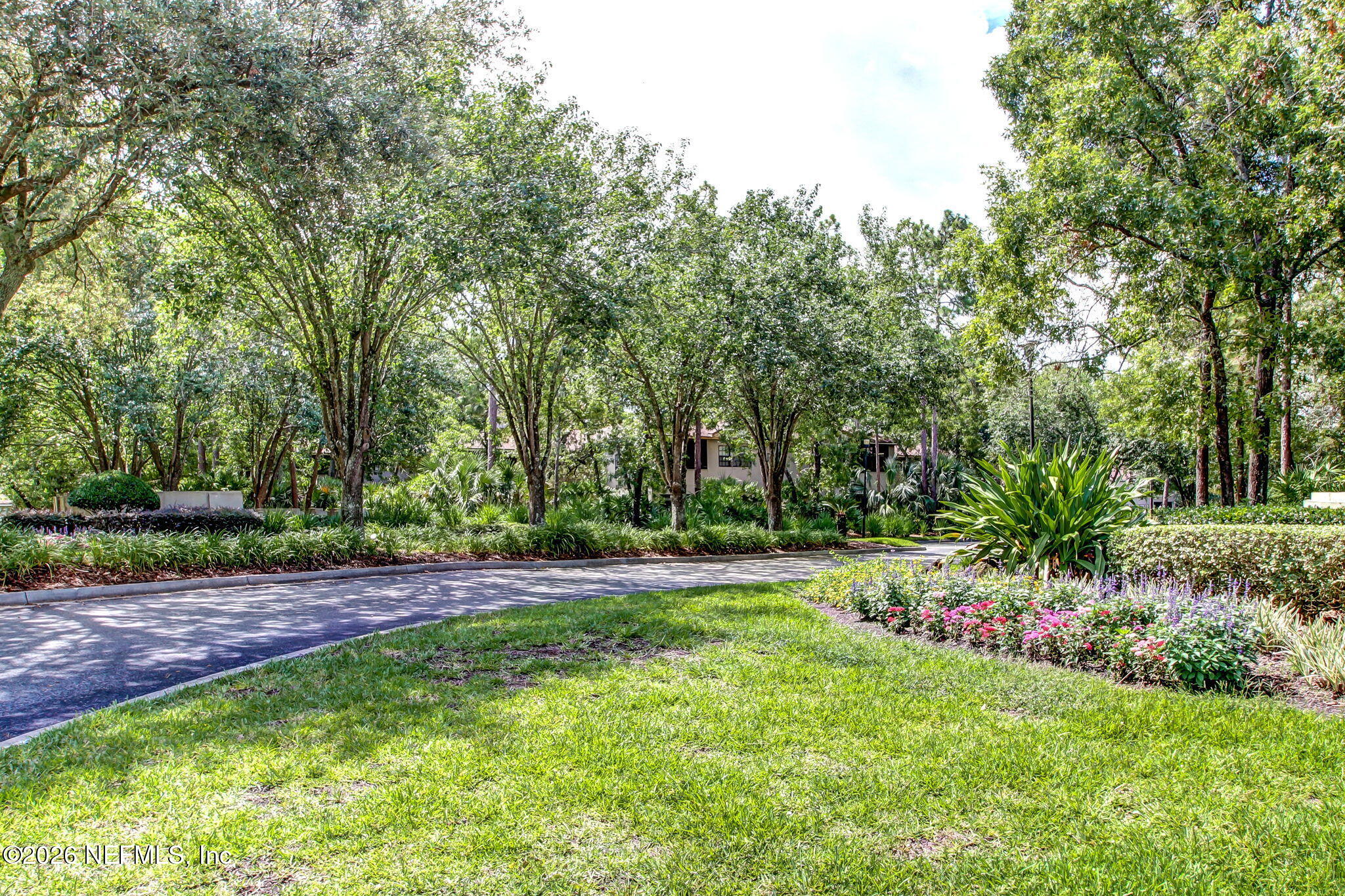 10150 Belle Rive Boulevard, Unit 1109 Jacksonville, FL 32256 - Photo 44 of 55 a view of a backyard with large trees