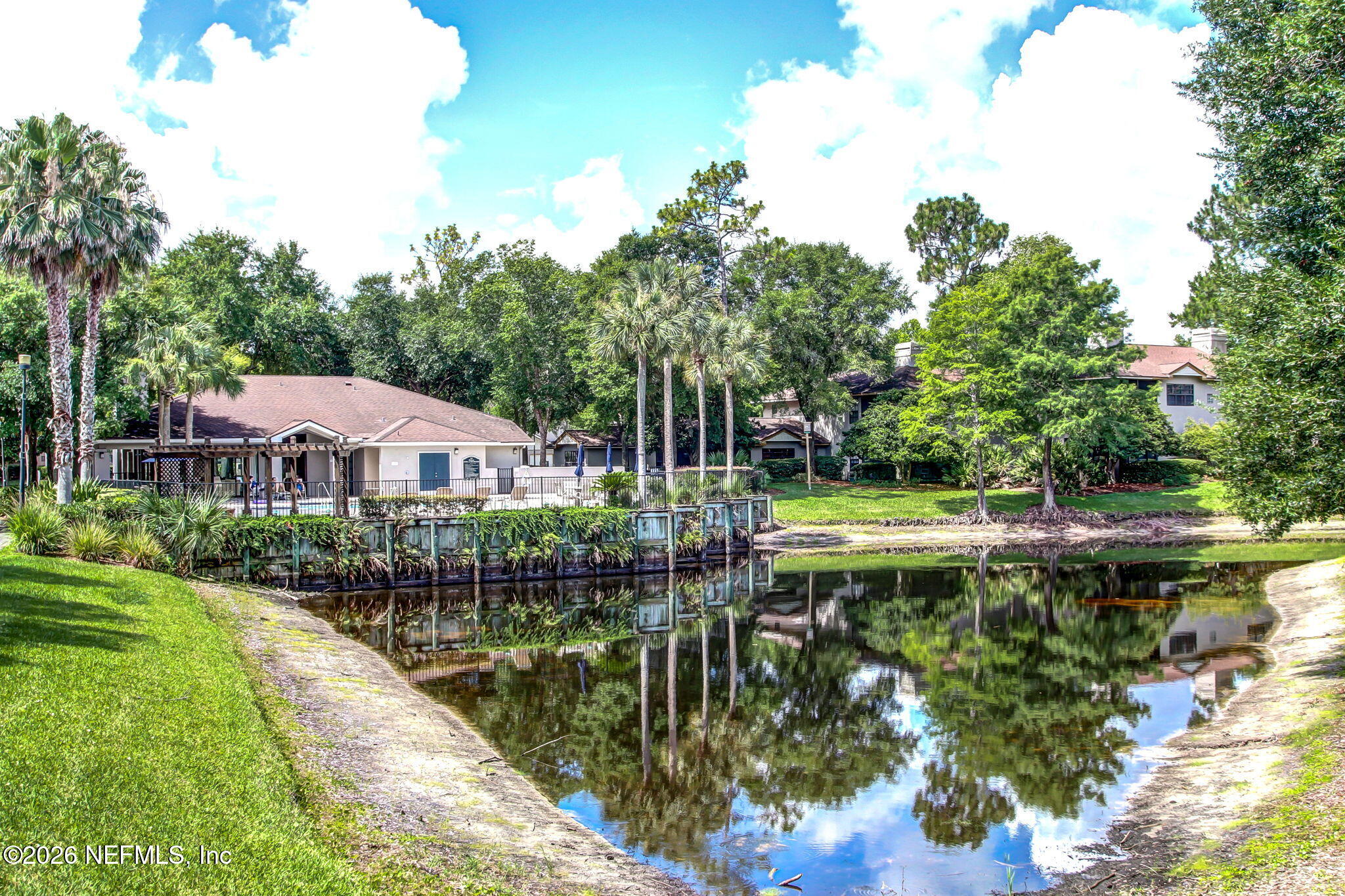 10150 Belle Rive Boulevard, Unit 1109 Jacksonville, FL 32256 - Photo 45 of 55 a view of a house with a yard and a garden